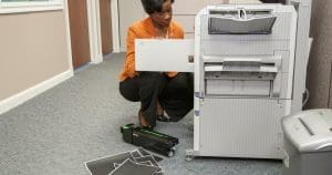worker trying to fix broken copier in Middle Tennessee office